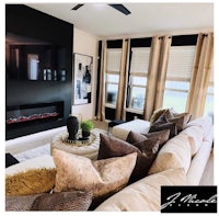 a living room with a fireplace and a flat screen tv