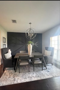 a dining room with a large table and chairs