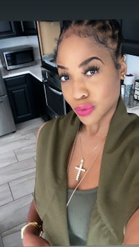 a woman is taking a selfie in a kitchen