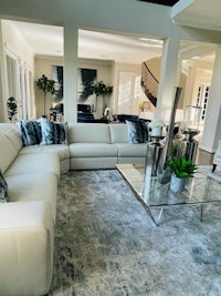 a living room with white couches and a coffee table