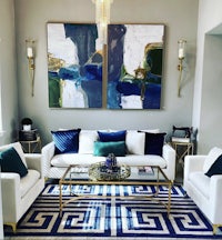 a living room with a blue and gold rug