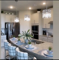 a kitchen with white counter tops and stainless steel appliances