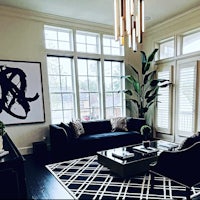 a living room with a black and white rug