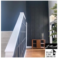 a black wall in a home with a staircase