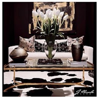 a black and gold living room with a vase of tulips