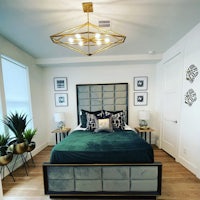 a bedroom with a bed and a lamp