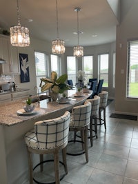 a kitchen with a large island and bar stools