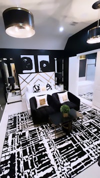 a black and white bedroom with a black and white rug
