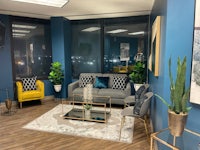 a blue and yellow office with a table and chairs