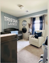 a baby boy's nursery with a blue and white theme